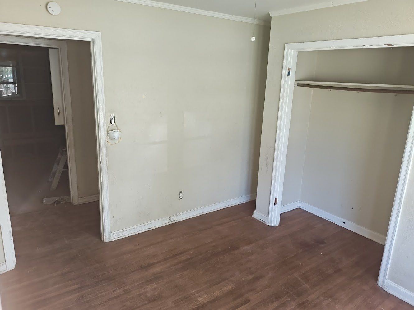 Bedroom with tired, plain finishes before renovation in Memphis, TN